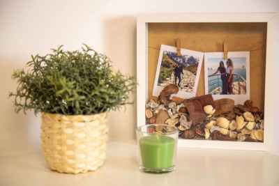 Cozy Home Decor with Framed Travel Memories & Green Candle – Modern Lifestyle Photography