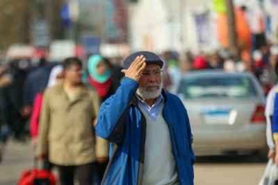 Elderly Man Shading His Eyes at Cairo International Book Fair 2017