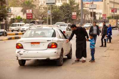 Father and Son Boarding a Taxi in Cairo Street