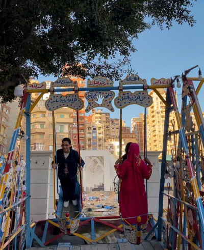 Girls Playing on Traditional “Moulid” Swings in Egypt