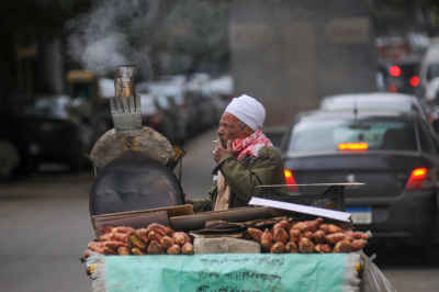 Sweet Potato Vendor Roasting on Cairo Street Cart