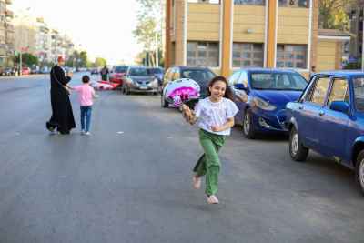 Little Girl Running with Balloon After Eid Prayers in Egypt