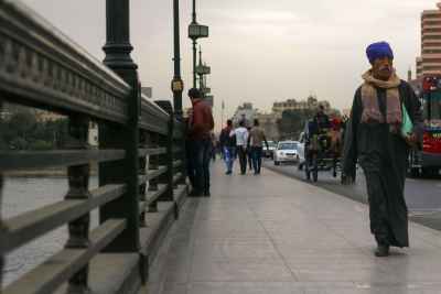 Man in Traditional Attire on Kasr el Nil Bridge in Cairo