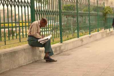 Man Reading a Newspaper in a Street in Cairo, Egypt 3