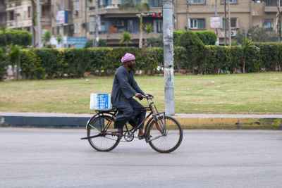 Man riding a bicycle in Cairo, Winter 2017