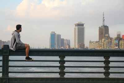 Man Sitting by the Nile — Cairo City View