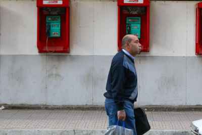 Man Walking on Mohamed Mahmoud Street in Front of the Telephone Booths 2