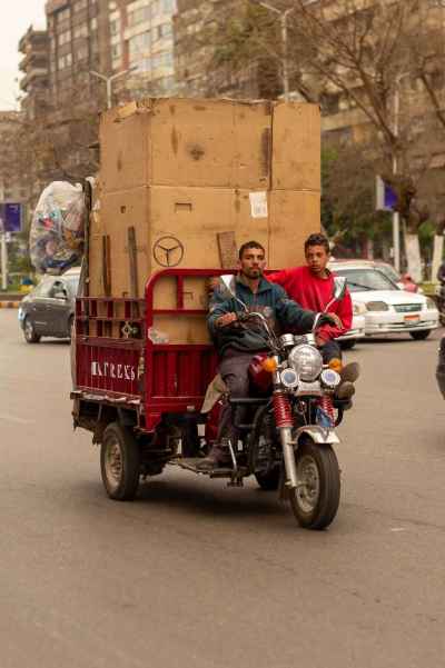 Men Transporting Cardboard Boxes on Motor Tricycle in Cairo 2