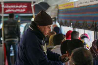 Middle-aged Man Standing on a Bus in Cairo