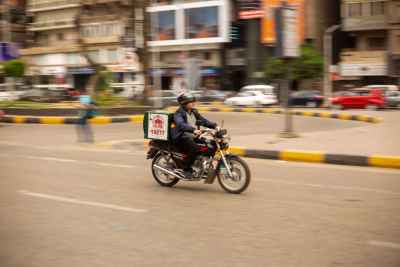 Motorcycle Delivery Rider in Cairo City Streets