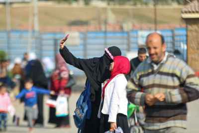 Niqab-Wearing Woman Taking a Selfie with Friend at Cairo International Book Fair 2017