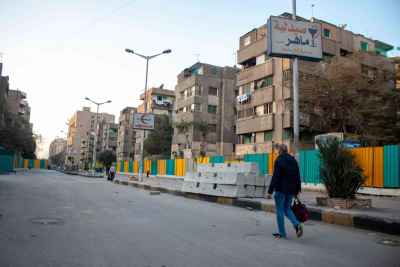 Pedestrian on Sudan Street During Cairo Metro Construction