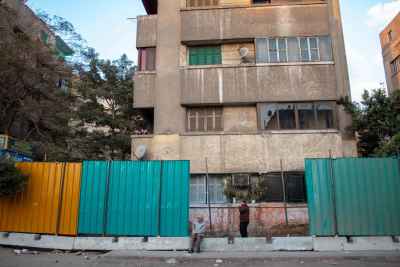 Two Men Resting by Metro Barriers, Sudan Street Cairo
