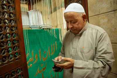 Maqam Caretaker with the Qur’an