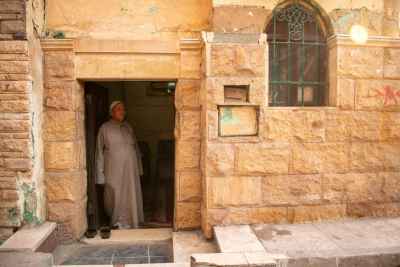 Maqam Caretaker at the Shrine Entrance