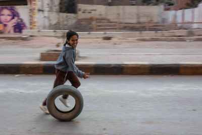 Child Rolling Tire While Running, Cairo Street