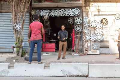 Hubcap Shop Owner Talks with Customer, Cairo Street