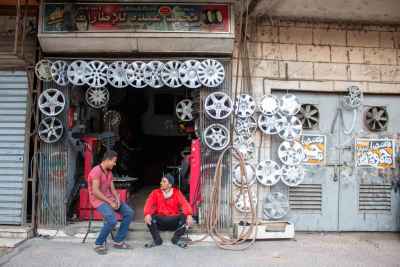 Tire Shop Workers Chatting Outside Cairo Street Garage