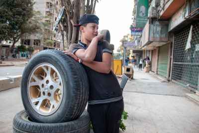Egyptian Boy Leaning on Car Tires, Sudan Street Cairo