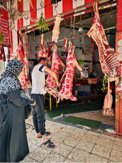Egyptian Butcher Serving Customers in a Traditional Market