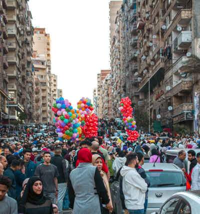 Morning of Eid in Alexandria with Crowded Streets and Balloons After Eid Prayer
