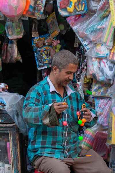 Toy Vendor Arranging Merchandise in Cairo