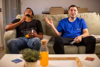 Two friends are enjoying a fun gaming session on PlayStation 2