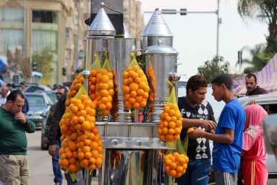 Vendor Selling Fresh Orange Juice from a Cart in Cairo, Egypt