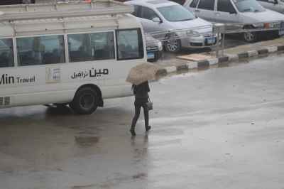 Woman Walking with Umbrella in Cairo