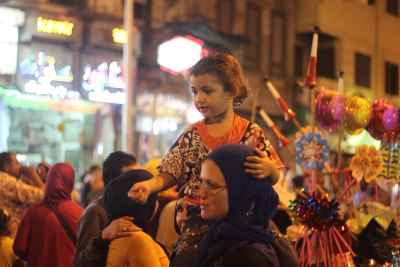Women Carrying Children on Their Shoulders During Festive Mawlid Celebration – Cairo, Egypt 2