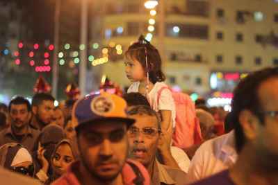 Women Carrying Children on Their Shoulders During Festive Mawlid Celebration – Cairo, Egypt 3