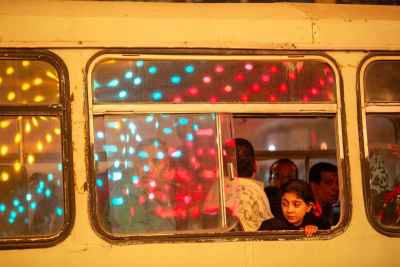 Young Girl Looking Out of a Bus Window During Mawlid Celebrations