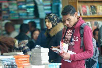 Young Man Reading at Cairo International Book Fair 2017