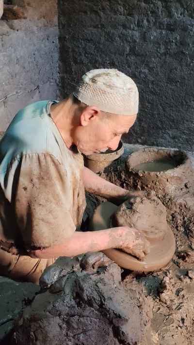 Elderly Potter Shaping Clay, Pottery Workshop Al-Monofeya