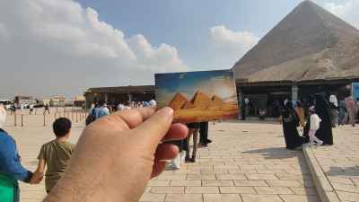 Hand Holding Giza Pyramids Entry Ticket, Great Pyramid Background