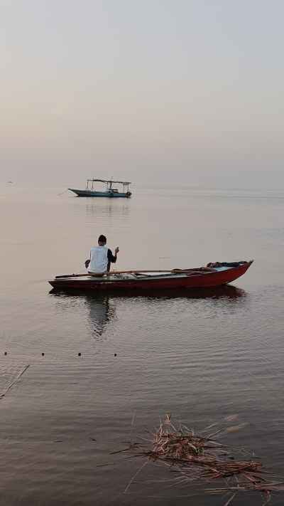 Fisherman in Wooden Boat, Lake Burullus at Dawn