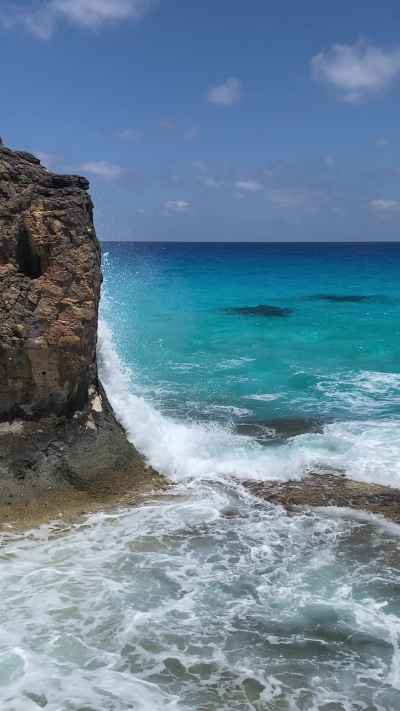 Turquoise Waves Crashing Against Rocky Mediterranean Coast