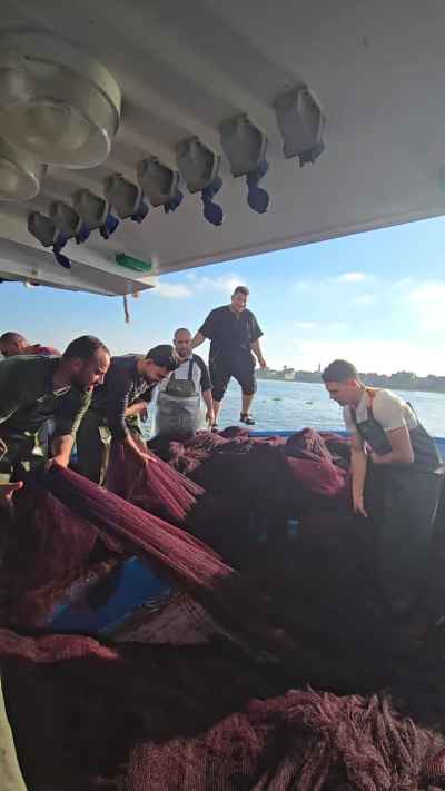 Egyptian Fishermen Sorting Nets on Nile Boat