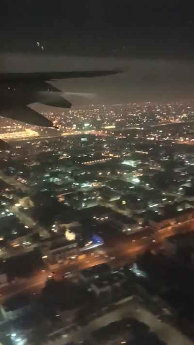 Dubai City Aerial Night View from Aircraft Window