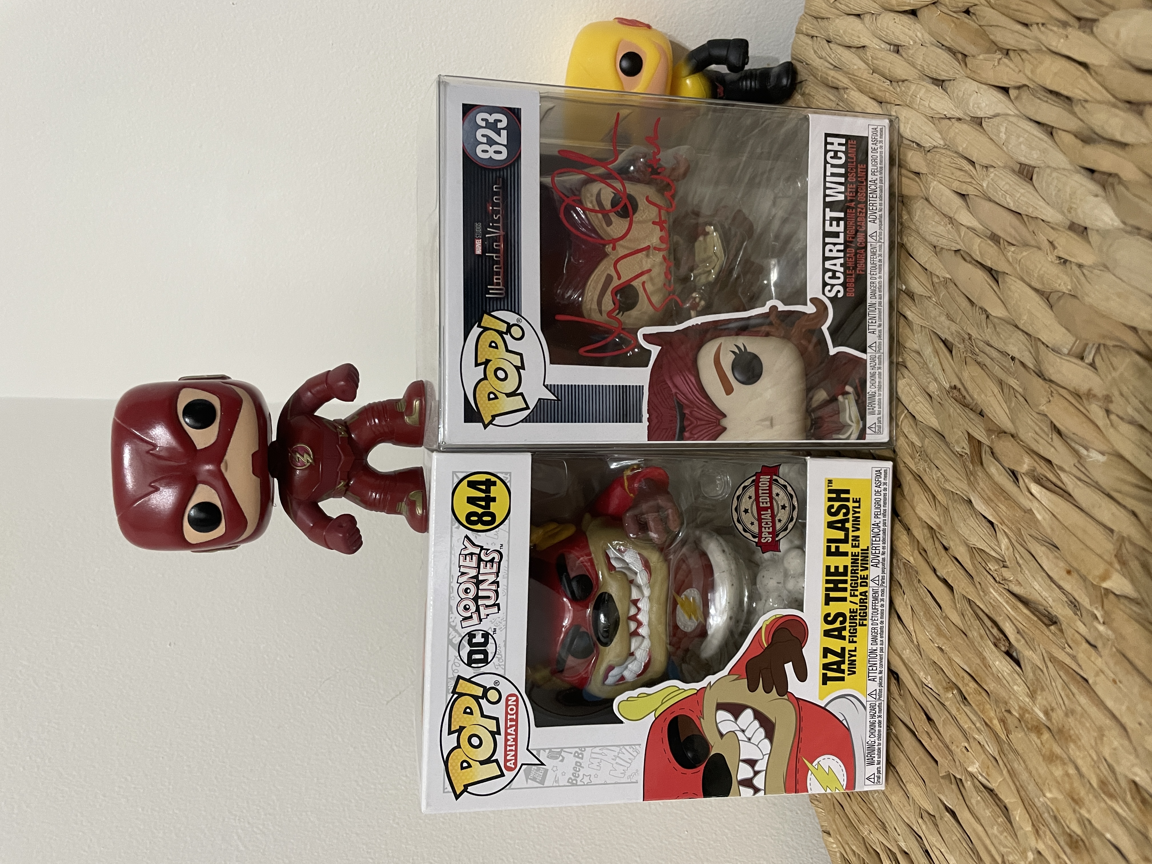 There POP Funkos: Taz from the Loony Tunes dressed as the Flash inside of his box; Wanda Maximoff as the Scarlet Witch as we saw her in Wandavision in her box; and Barry Allen as The Flash from The Flash TV show standing on top of the two boxes. Reserve Flash aka Eobard Thawne POP Funko standing behind Wanda's box, creeping.