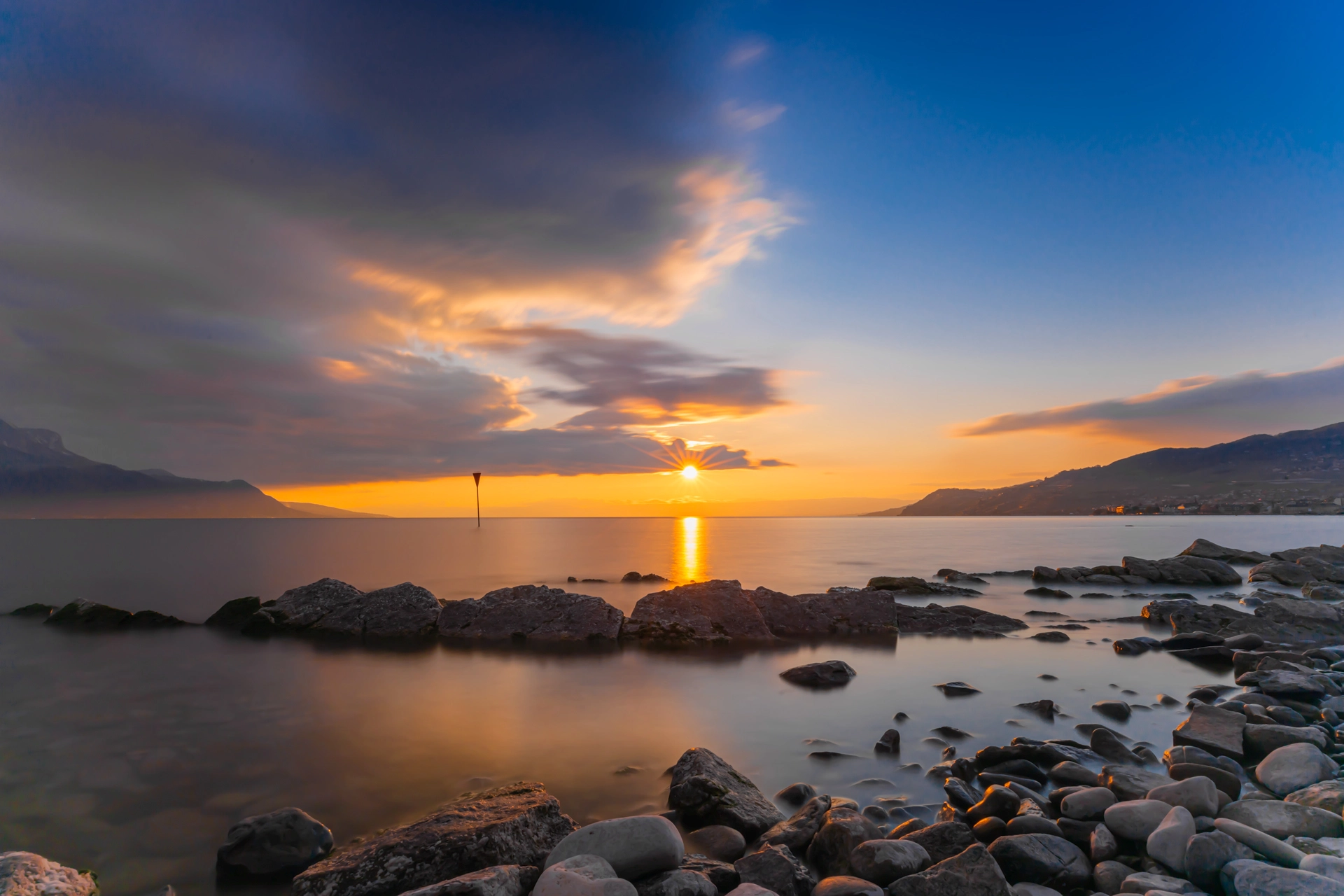 Serenity in Stone: Sunset Reflections on Lake Geneva