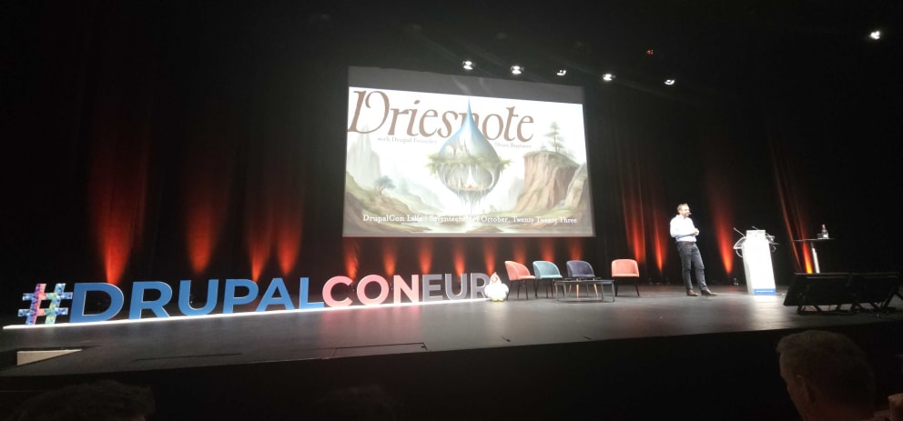 Stage with a presentation in the background saying Driesnote