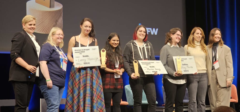 Women collecting awards on a stage