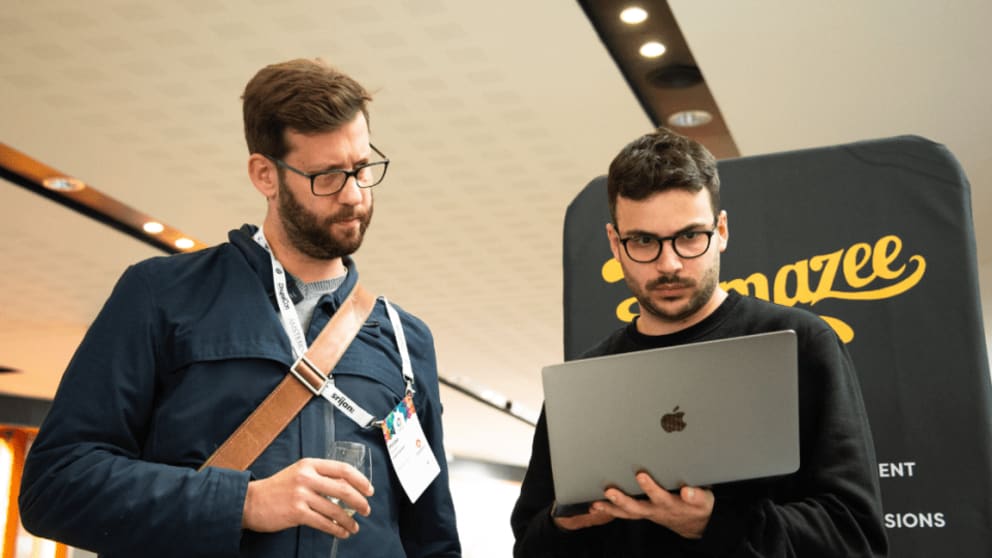 Philipp Melab and Mattia Simonato confering over a laptop