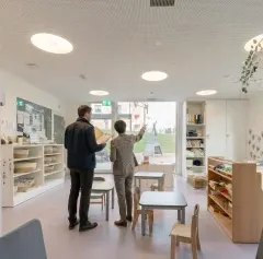 A company representative visiting a childcare centre with a pop e poppa advisor to explore tailored childcare solutions for employees and identify the model that best fits the organisation’s needs.