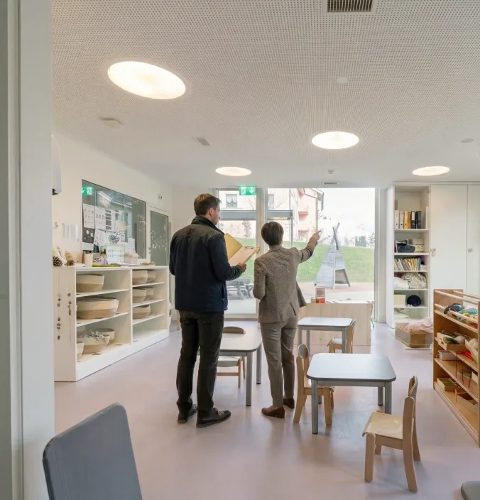 A company representative visiting a childcare centre with a pop e poppa advisor to explore tailored childcare solutions for employees and identify the model that best fits the organisation’s needs.