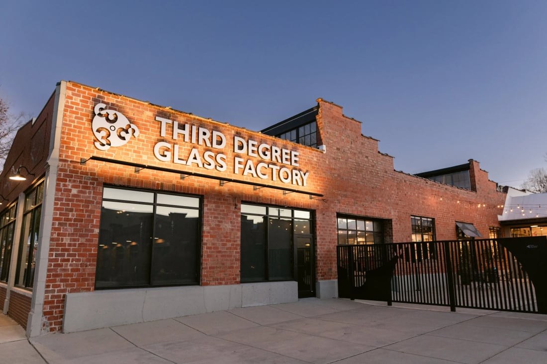 The brick exterior of Third Degree Glass at dusk