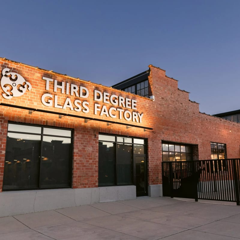 The brick exterior of Third Degree Glass at dusk
