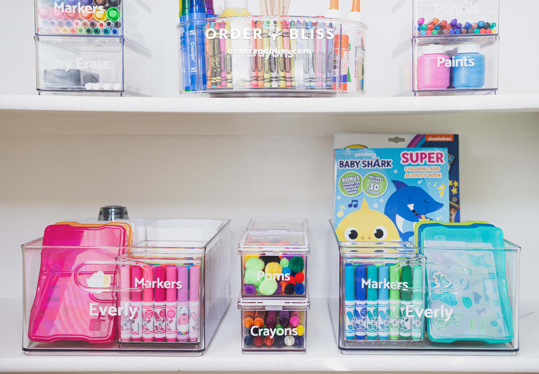 Clear organizing containers with markers and crayons