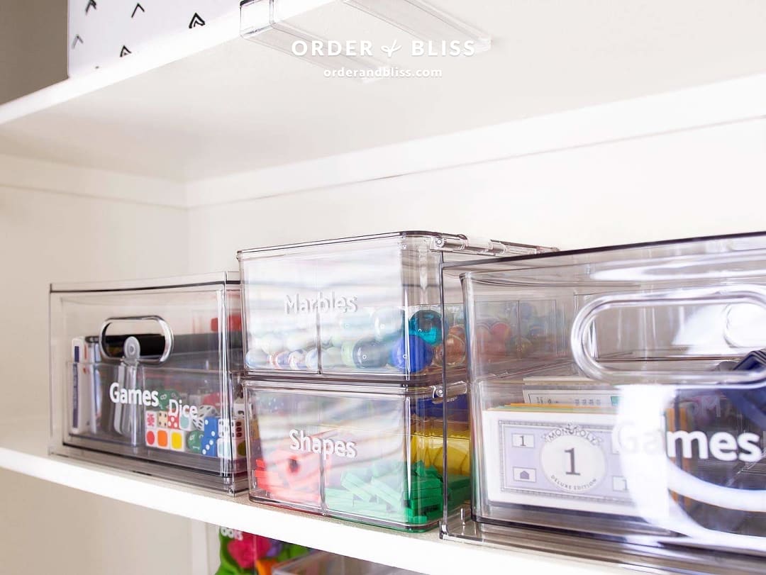 Clear organization bins with marbles, shapes, and games